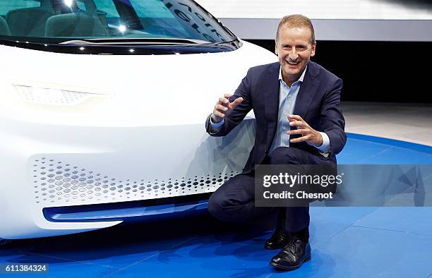 Herbert Diess, head of the Volkswagen brand poses next to the new Volkswagen I.D. Concept electric automobile during the press day of the Paris Motor...