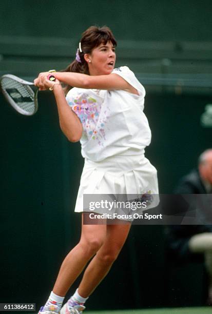 Jennifer Capriati of the United States hits a return during a women's singles match at the Wimbledon Lawn Tennis Championships circa 1990 at the All...