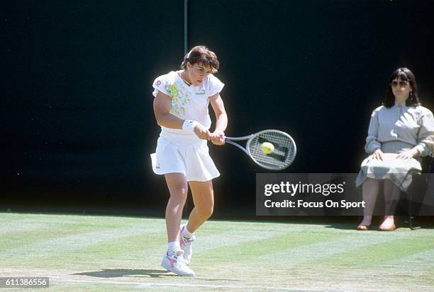 Jennifer Capriati of the United States hits a return during a women's singles match at the Wimbledon Lawn Tennis Championships circa 1990 at the All...