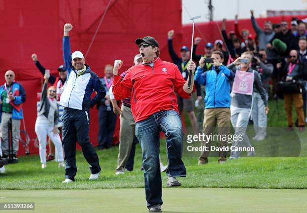 Fan David Johnson of North Dakota reacts after being pulled from the crowd and making a putt on the eighth green during practice prior to the 2016...
