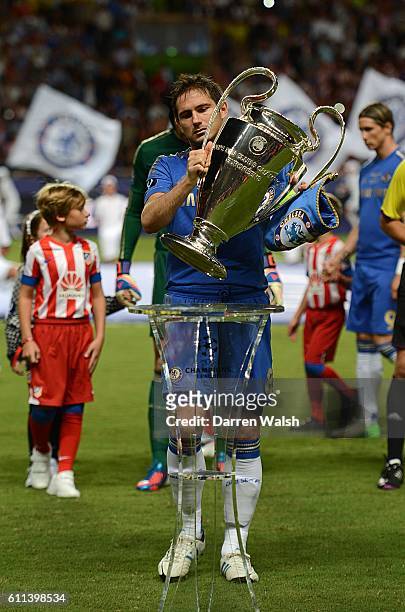 Chelsea's Frank Lampard puts the Champions League Trophy on its stand before the match