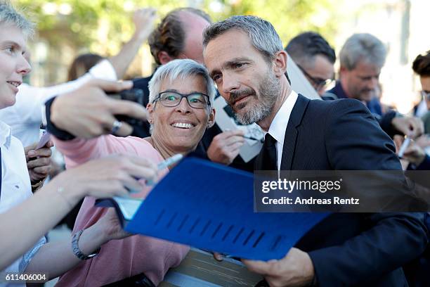 Jerome Salle writes autographs and takes selfies as he attends the 'L'Odyssee' premiere during the 12th Zurich Film Festival on September 29, 2016 in...