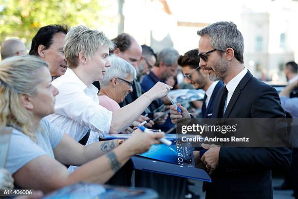 Jerome Salle writes autographs and takes selfies as he attends the 'L'Odyssee' premiere during the 12th Zurich Film Festival on September 29, 2016 in...