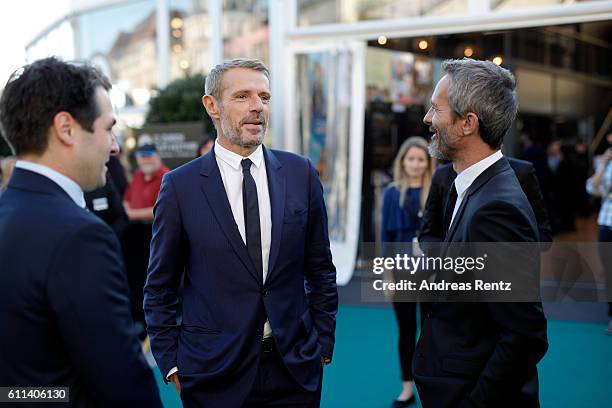 Festival director Karl Spoerri, Lambert Wilson and Jerome Salle have a chat at the 'L'Odyssee' premiere during the 12th Zurich Film Festival on...