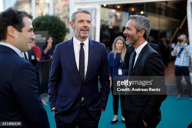 Festival director Karl Spoerri, Lambert Wilson and Jerome Salle have a chat at the 'L'Odyssee' premiere during the 12th Zurich Film Festival on...