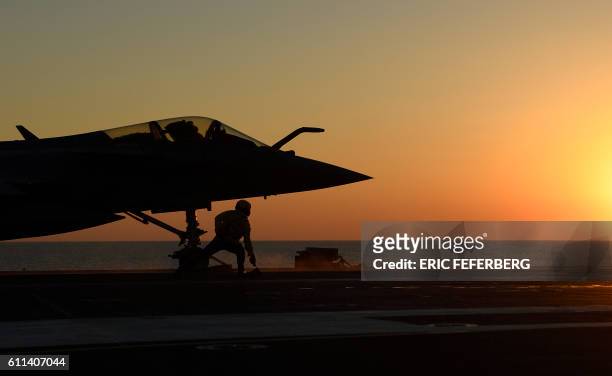 This picture taken on September 29 shows a Rafale Marine combat aircraft being catapulted from the French aircraft carrier Charles de Gaulle as it...
