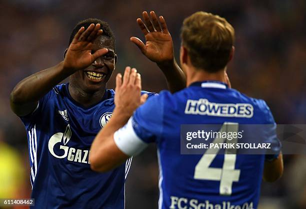 Schalke's defender Benedikt Hoewedes and Schalke's Swiss midfielder Breel Embolo celebrate scoring during the UEFA Europa League first-leg football...