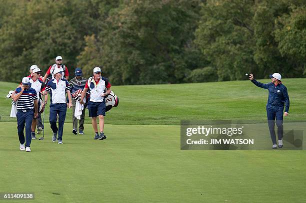 S Ryan Moore arrives at the fairway during a practice round ahead of the 41st Ryder Cup at Hazeltine National Golf Course in Chaska, Minnesota,...