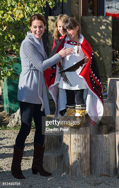 Catherine, Duchess of Cambridge meets a young performer after watchig a cultural welcome on September 28, 2016 in Carcross, Canada.