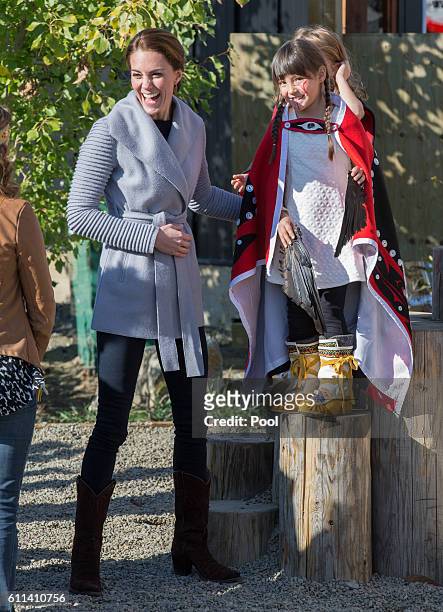 Catherine, Duchess of Cambridge meets a young performer after watchig a cultural welcome on September 28, 2016 in Carcross, Canada.
