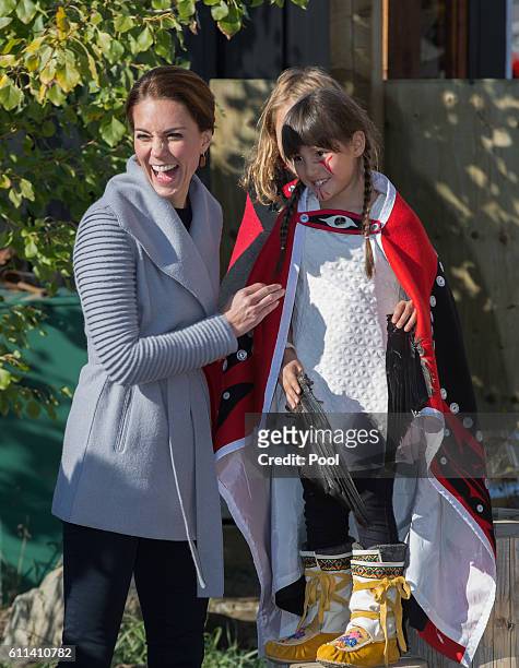 Catherine, Duchess of Cambridge meets a young performer after watchig a cultural welcome on September 28, 2016 in Carcross, Canada.
