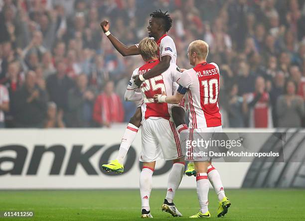 Kasper Dolberg of Ajax is congratulated by teammates Bertrand Traore and Davy Klaassen of Ajax after scoring the opening goal during the UEFA Europa...