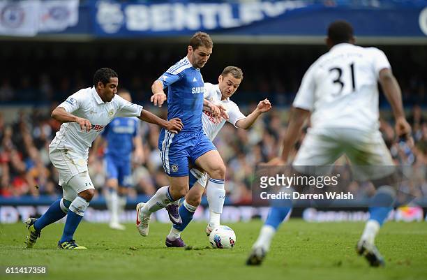 Branislav Ivanovic of Chelsea goes past Shaun Maloney and Jean Beausejour of Wigan Athletic during the Barclays Premier League match between Chelsea...