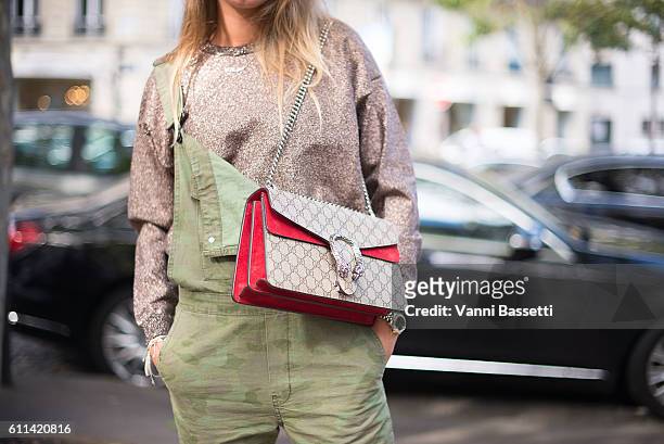 Bo Galle poses wearing a Zara overall, Other Stories sweatshirt and Gucci bag after the Balmain show at the Hotel Potocki during Paris Fashion Week...