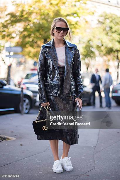 Jessica Mercedes poses wearing Puma Fenty shoes and Gucci bag after the Ann Demeulemeester show at the Theatre de Chaillot during Paris Fashion Week...