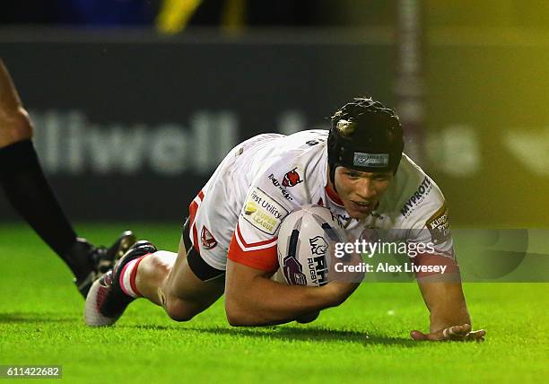 Jonny Lomax of St Helens dives over the line to score their first try during the First Utility Super League Semi Final match between Warrington...