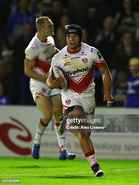 Jonny Lomax of St Helens breaks through to score their first try during the First Utility Super League Semi Final match between Warrington Wolves and...
