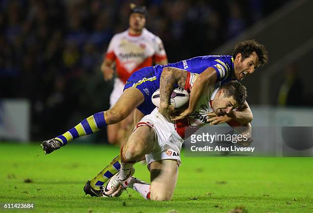 Mark Percival of St Helens is tackled by Stefan Ratchford of Warrington Wolves during the First Utility Super League Semi Final match between...
