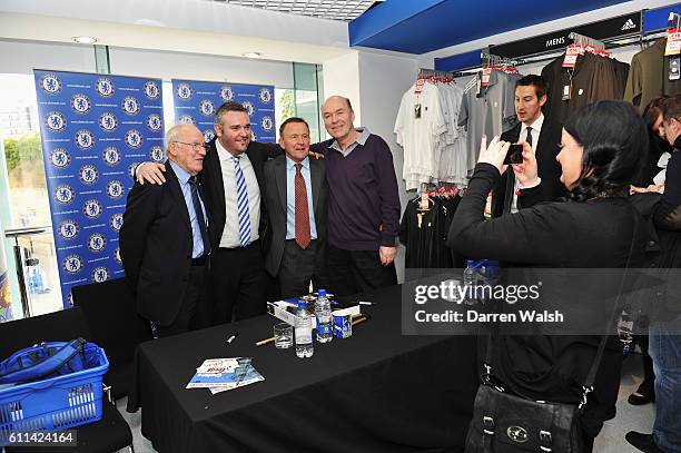 Former Chelsea players Frank Blunstone, John Hollins and John Dempsey pose for photographs for fans before the Barclays Premier League match between...