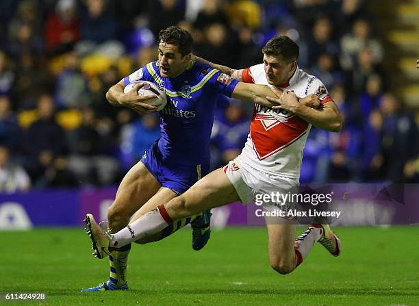 Mark Percival of St Helens tackles Toby King of Warrington Wolves during the First Utility Super League Semi Final match between Warrington Wolves...