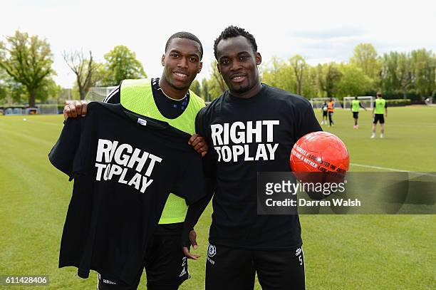 Daniel Sturridge, Michael Essien of Chelsea with Right To Play ball after a training session at the Cobham training ground on May 15, 2012 in Cobham,...