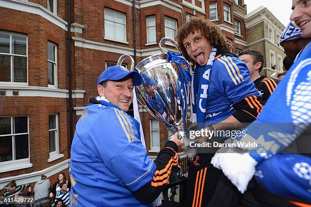 David Luiz holds the Champions League trophy during the Chelsea victory parade following their UEFA Champions League and FA Cup victories on May 20,...