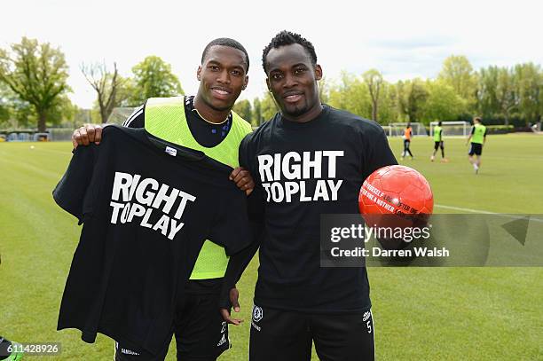 Daniel Sturridge, Michael Essien of Chelsea with Right To Play ball after a training session at the Cobham training ground on May 15, 2012 in Cobham,...