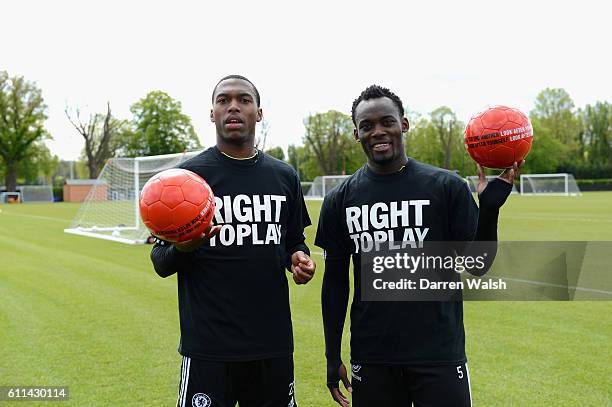 Daniel Sturridge, Michael Essien of Chelsea with Right To Play ball after a training session at the Cobham training ground on May 15, 2012 in Cobham,...