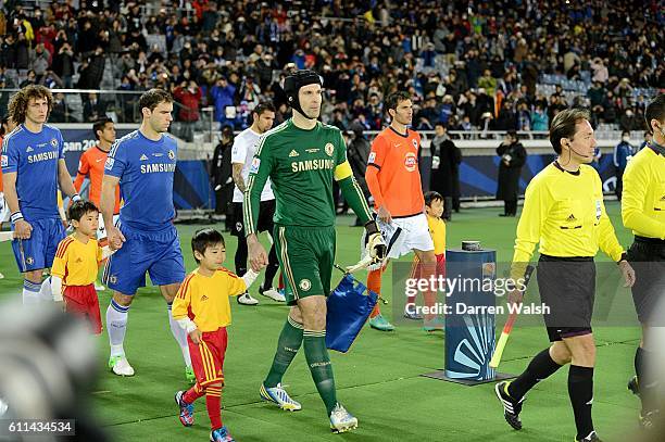 Chelsea captain and goalkeeper Petr Cech walks on to the pitch with a mascot