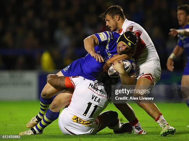 Chris Hill of Warrington Wolves is tackled by Jon Wilkin and Atelea Vea of St Helens during the First Utility Super League Semi Final match between...