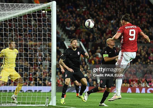 Manchester United's Swedish striker Zlatan Ibrahimovic heads the ball to scores his team's first goal during the UEFA Europa League group A football...