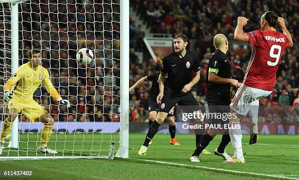 Manchester United's Swedish striker Zlatan Ibrahimovic heads the ball to scores his team's first goal during the UEFA Europa League group A football...