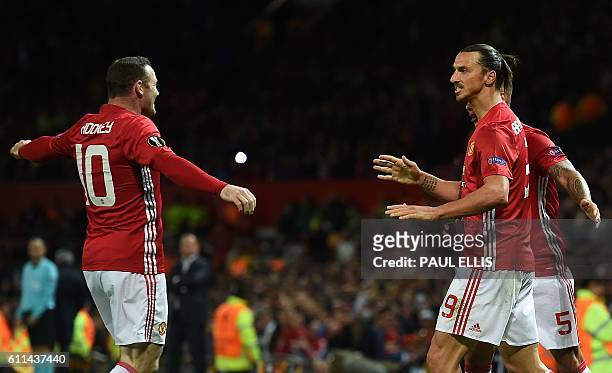 Manchester United's Swedish striker Zlatan Ibrahimovic celebrates scoring his team's first goal with Manchester United's English striker Wayne Rooney...