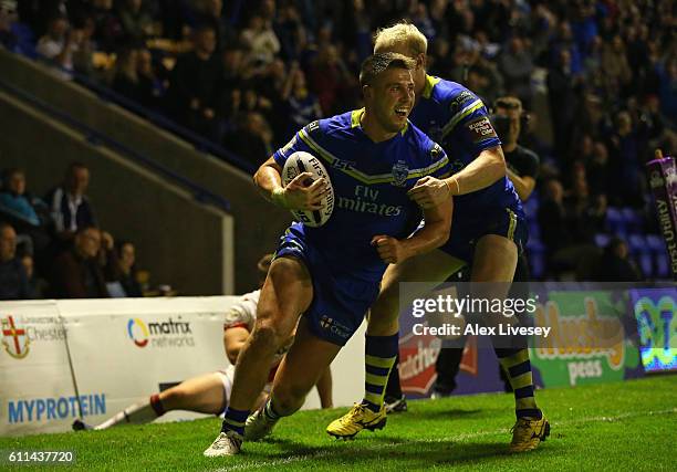 Tom Lineham of Warrington Wolves celebrates after scoring a try with Rhys Evans during the First Utility Super League Semi Final match between...