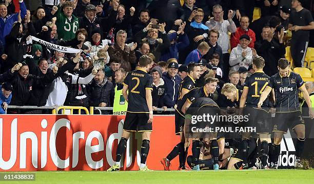 Dundalk's Irish striker Ciaran Kilduff is mobbed by teammates as he celebrates scoring his team's first goal during the UEFA Europa League group D...