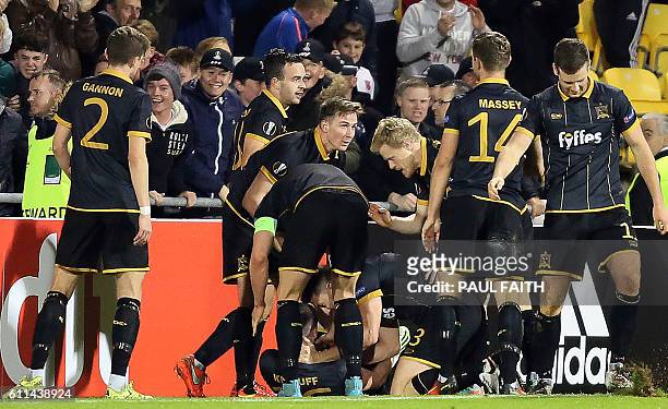 Dundalk's Irish striker Ciaran Kilduff is mobbed by teammates as he celebrates scoring his team's first goal during the UEFA Europa League group D...