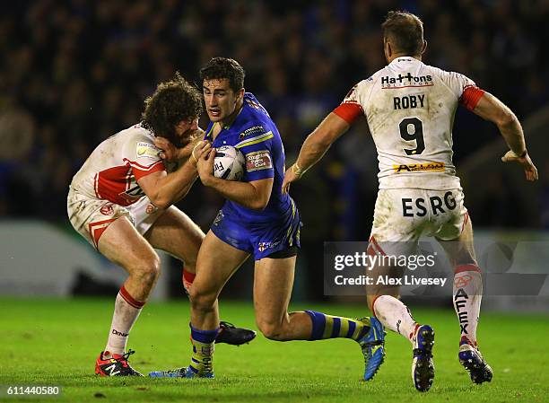 Toby King of Warrington Wolves is tackled by Kyle Amor of St Helens during the First Utility Super League Semi Final match between Warrington Wolves...