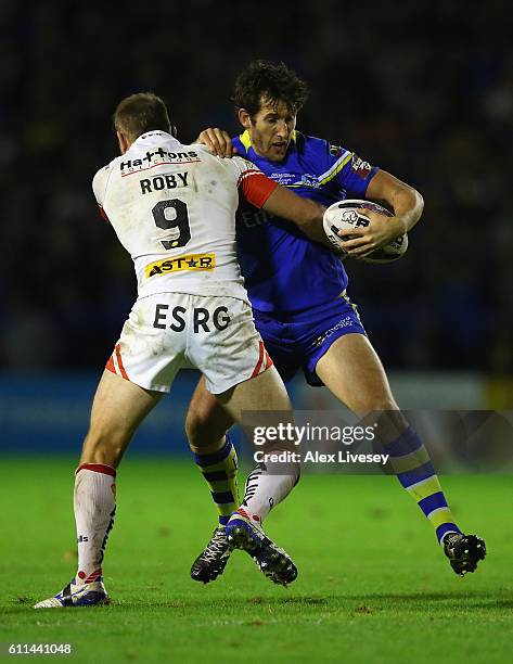 Stefan Ratchford of Warrington Wolves is tackled James Roby of St Helens during the First Utility Super League Semi Final match between Warrington...