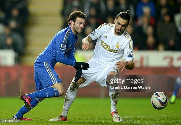 Chelsea's Juan Mata and Swansea City's Chico battle for the ball