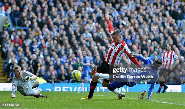 Brentford's Harlee Dean attempts to prevent Chelsea's Demba Ba from getting a shot on goal