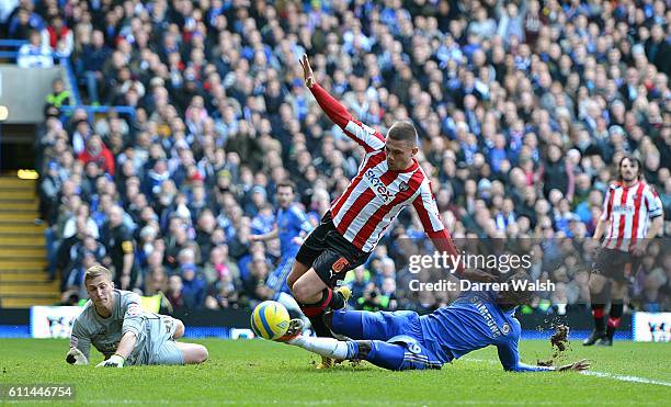 Brentford's Harlee Dean attempts to prevent Chelsea's Demba Ba from getting a shot on goal