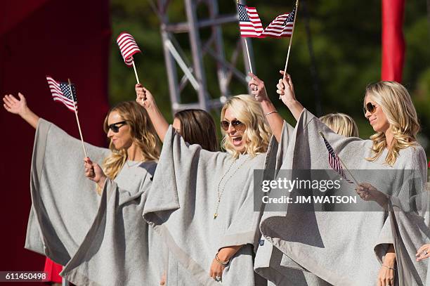 Nicole Moore , wife of US golfer Ryan Moore; and Mandy Sneaker , wife of US golfer Brandt Sneaker; cheer during the Opening Ceremony of the 41st...