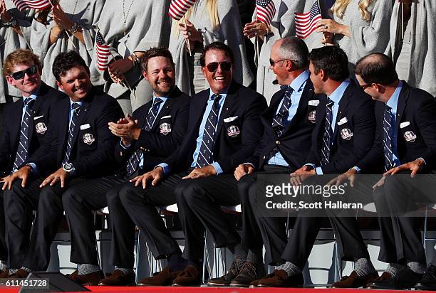 Brandt Snedeker, Patrick Reed, J.B. Holmes, Phil Mickelson, Matt Kuchar, Brooks Koepka and Zach Johnson of the United States react on stage during...