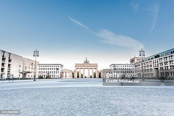street by brandenburg gate against sky - berlin stock pictures, royalty-free photos & images