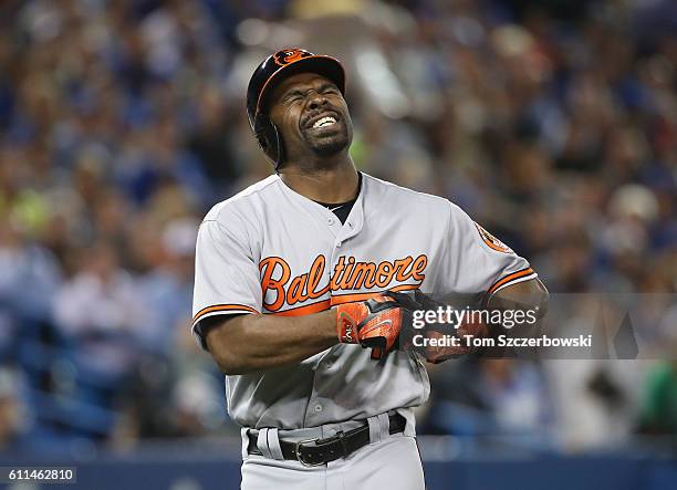 Michael Bourn of the Baltimore Orioles reacts after fouling a ball off his leg in the fourth inning during MLB game action against the Toronto Blue...