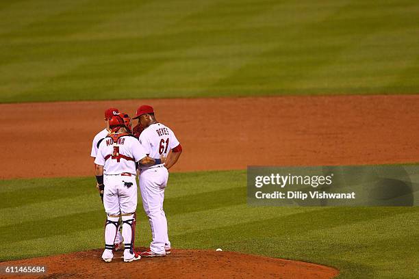 Yadier Molina talks to starter Alex Reyes of the St. Louis Cardinals during a Cincinnati Reds at bat in the sixth inning at Busch Stadium on...