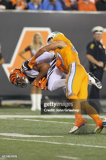 Spencer Paysinger of the Miami Dolphins tackles C.J. Uzomah of the Cincinnati Bengals during the second quarter at Paul Brown Stadium on September...