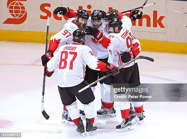 Patrice Bergeron of Team Canada is congratulated by his teammates after scoring a third period goal against Team Europe during Game Two of the World...