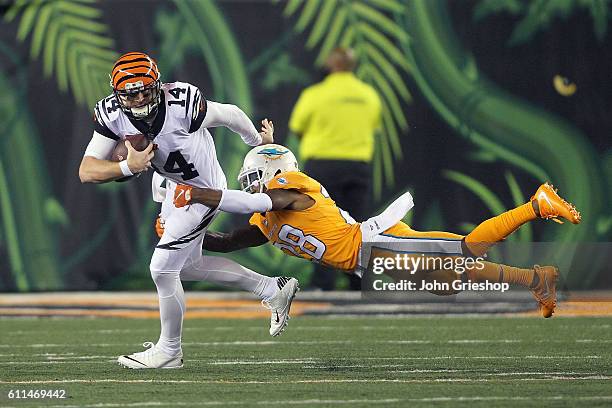 Andy Dalton of the Cincinnati Bengals is tackled by Bobby McCain of the Miami Dolphins during the third quarter at Paul Brown Stadium on September...