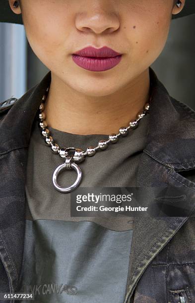 Lynn Kim Do wearing cargo green Isabella Rose Taylor cotton tee, chunky silver meridian ball chain Urban Outfitters choker necklace with ring...